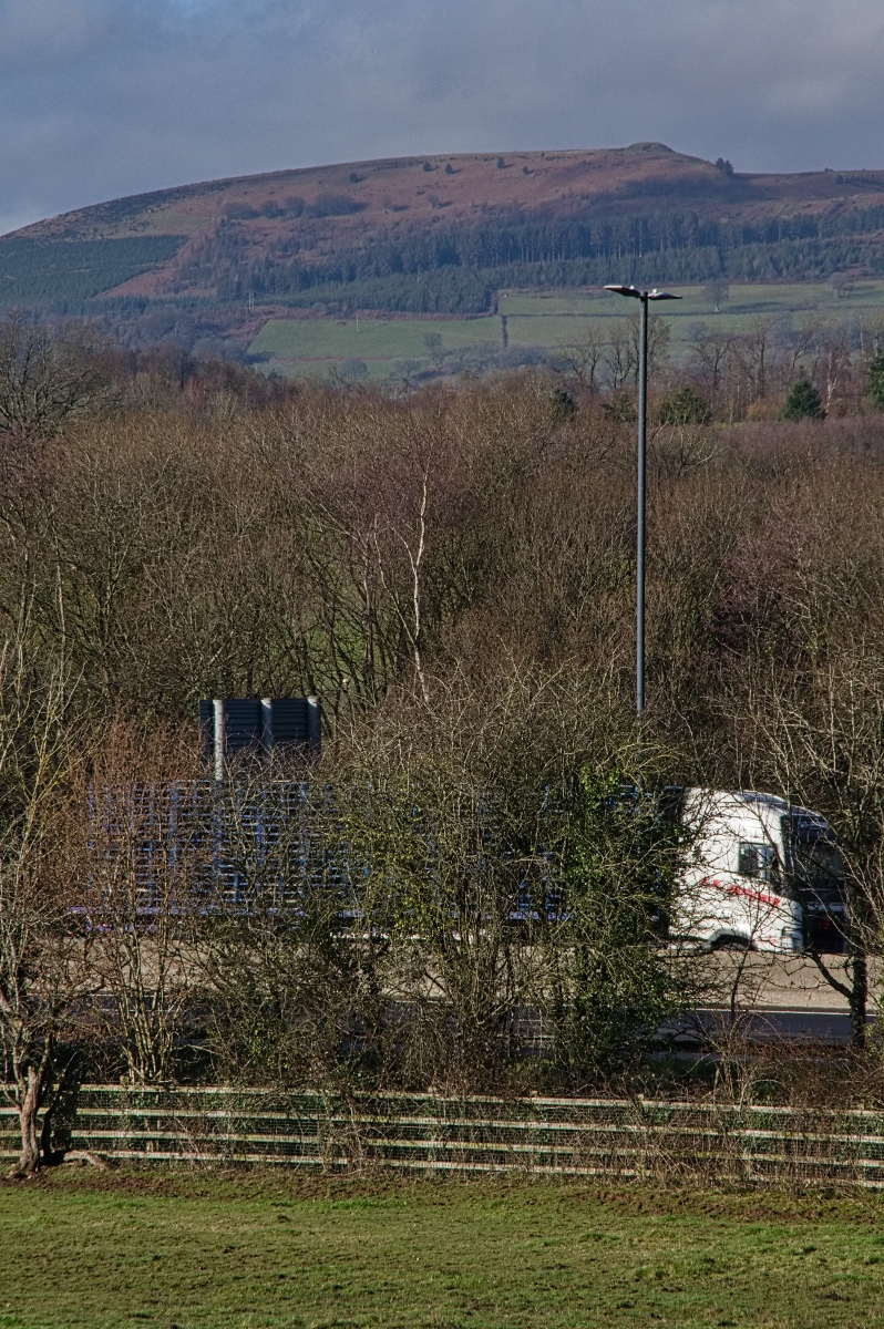 Twmbarlwm overlooking the motorway traffic (copyright Graham Porritt) Twmbarlwm